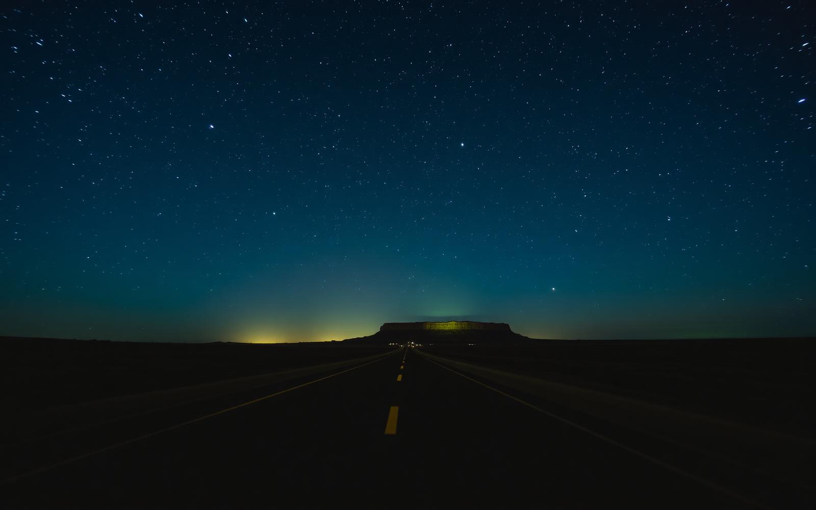 A strange light above a remote desert landscape